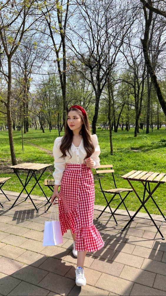 white puff sleeve blouse paired with a red gingham skirt